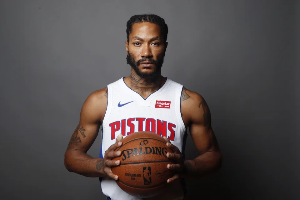 Basketballspieler in Ball in den Händen vor grauem Hintergrund