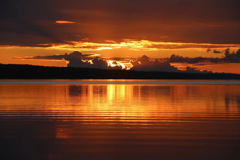 Schöner Sonnenuntergang in den Wolken auf Horizont am See