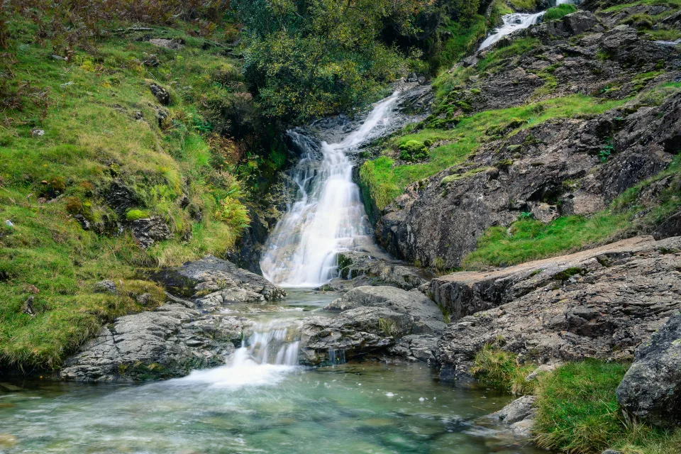 Gebirgsbach fließt über Felsen im Fluss