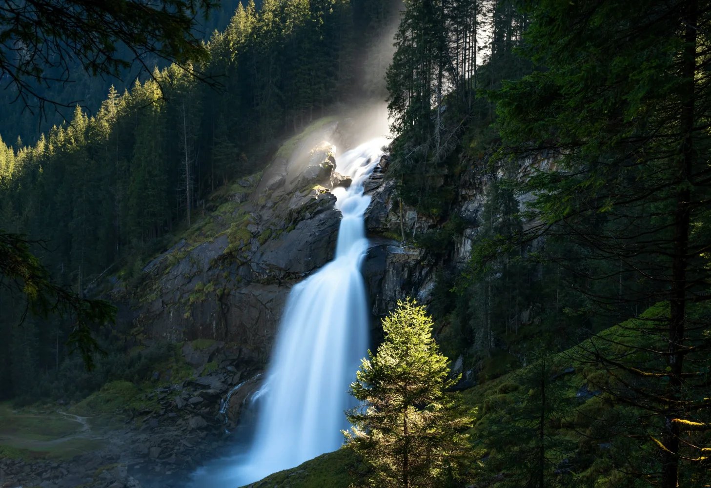 Wasserfall an einer Felswand im Wald