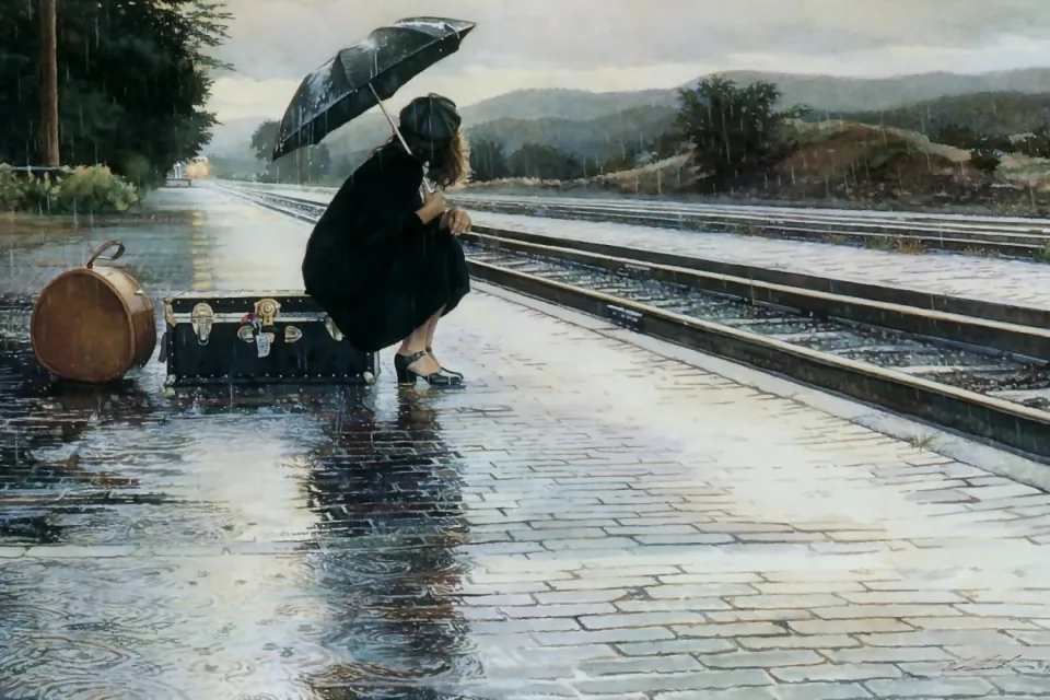 Frau mit Regenschirm am Bahnsteig