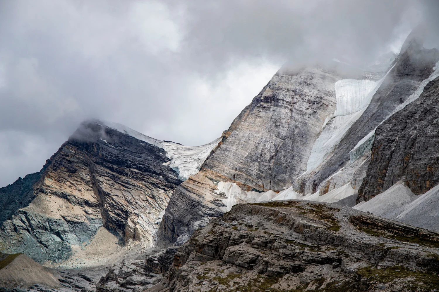 Hohe steinerne Berge in weißen Wolken