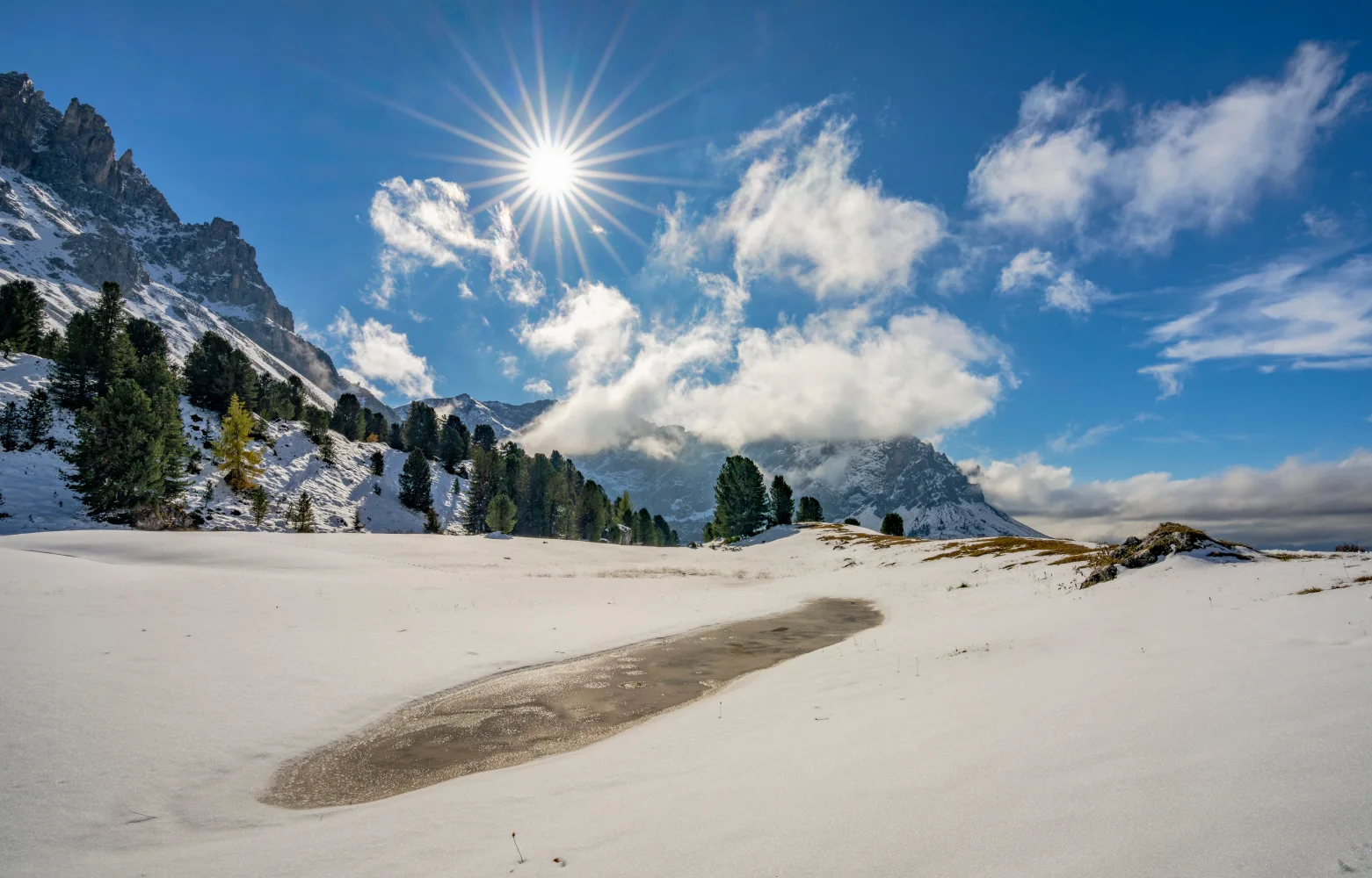 Leuchtende Sonne über Berge bei See